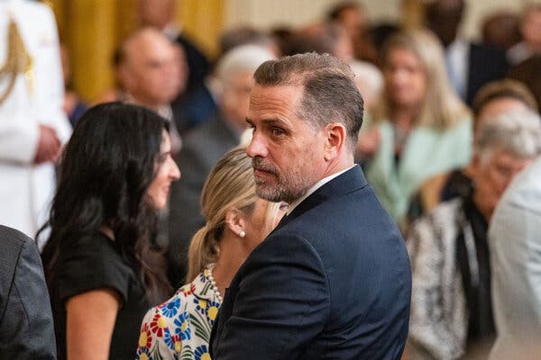 Hunter Biden wearing a suit in front of a crowd at the White House.